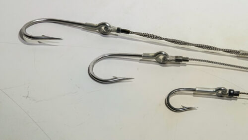 A group of fishing hooks on top of a table.